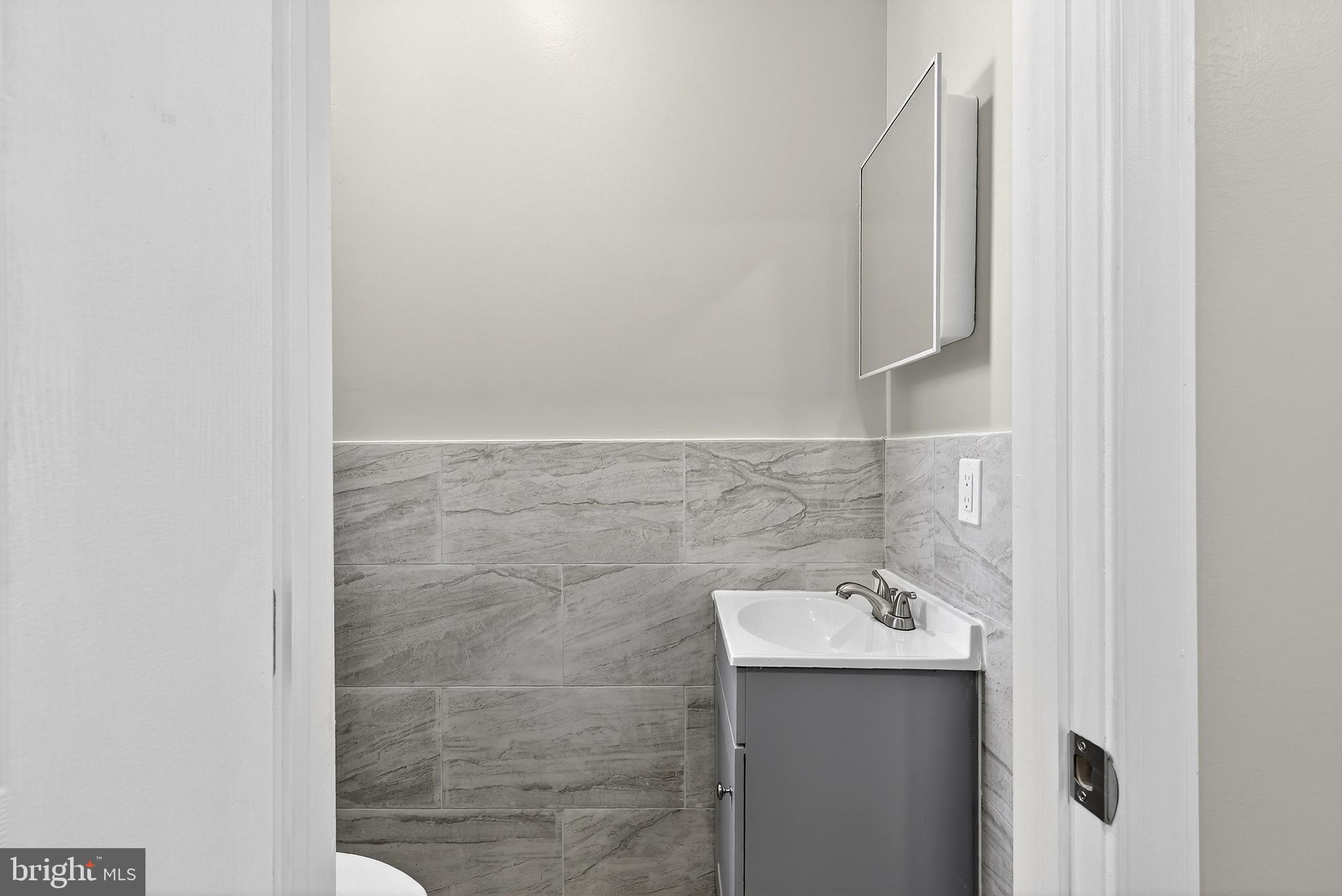 5443 Irving Street Philadelphia, PA 19139 - Photo 19 of 50 a bathroom with a sink and mirror