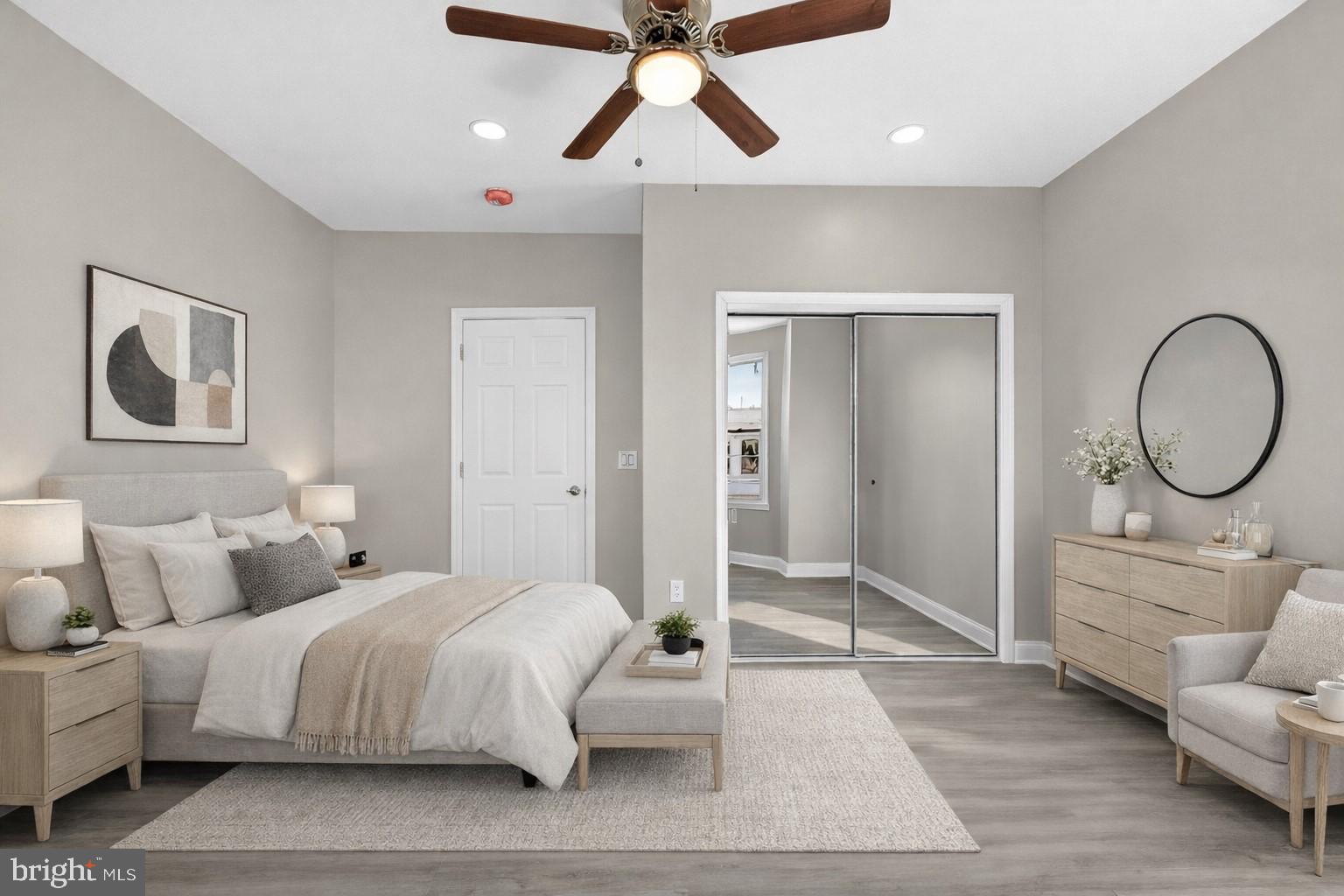 5443 Irving Street Philadelphia, PA 19139 - Photo 20 of 50 a spacious bedroom with a bed a mirror and paintings on the wall