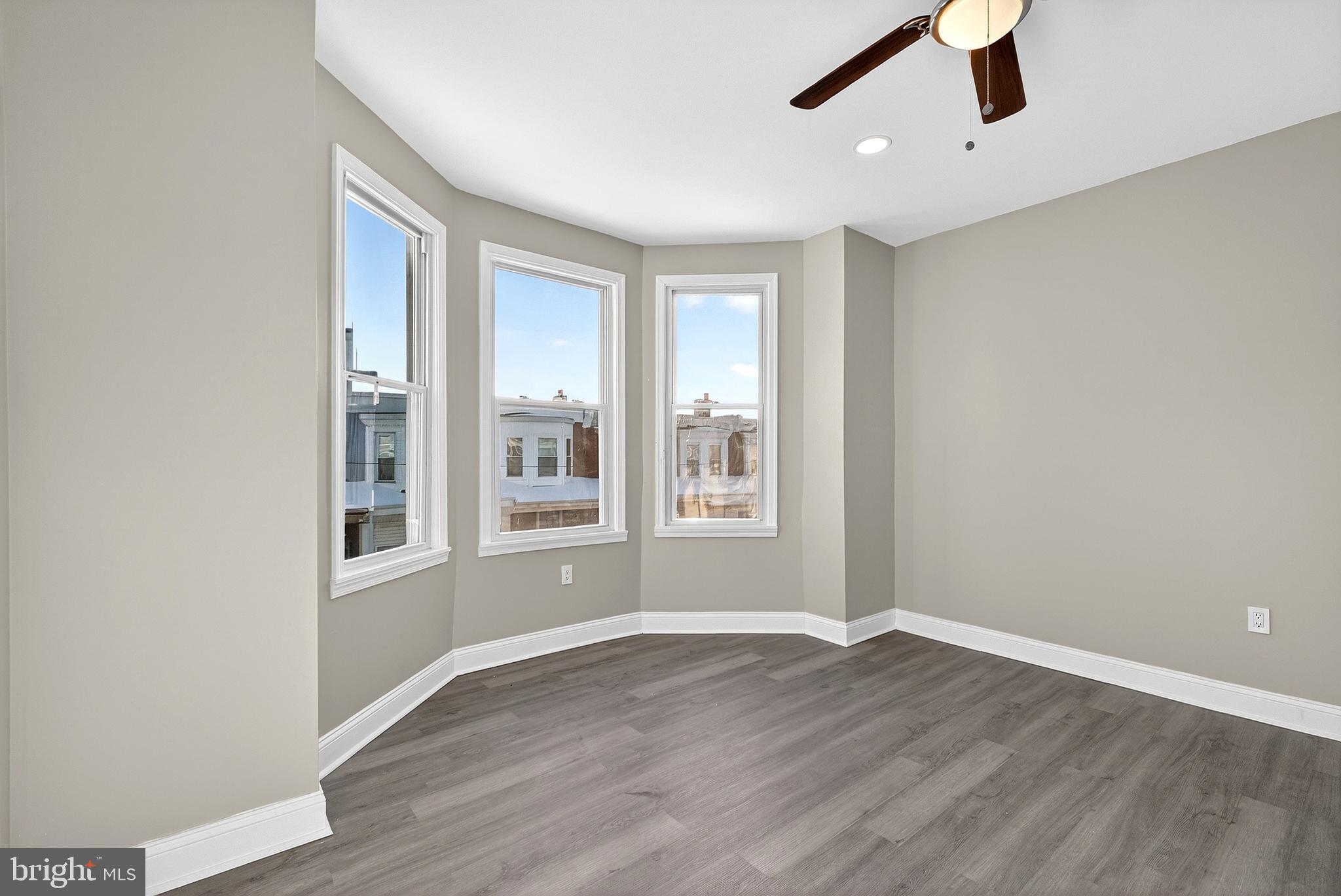 5443 Irving Street Philadelphia, PA 19139 - Photo 22 of 50 an empty room with wooden floor and windows