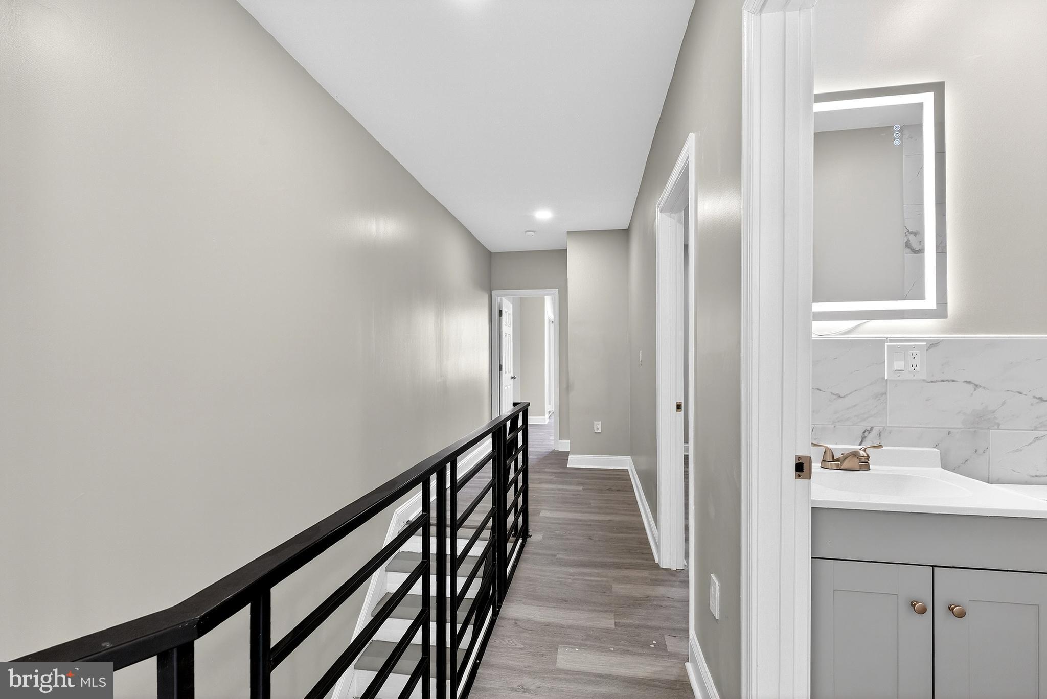 5443 Irving Street Philadelphia, PA 19139 - Photo 25 of 50 a view of a hallway with wooden floor and staircase