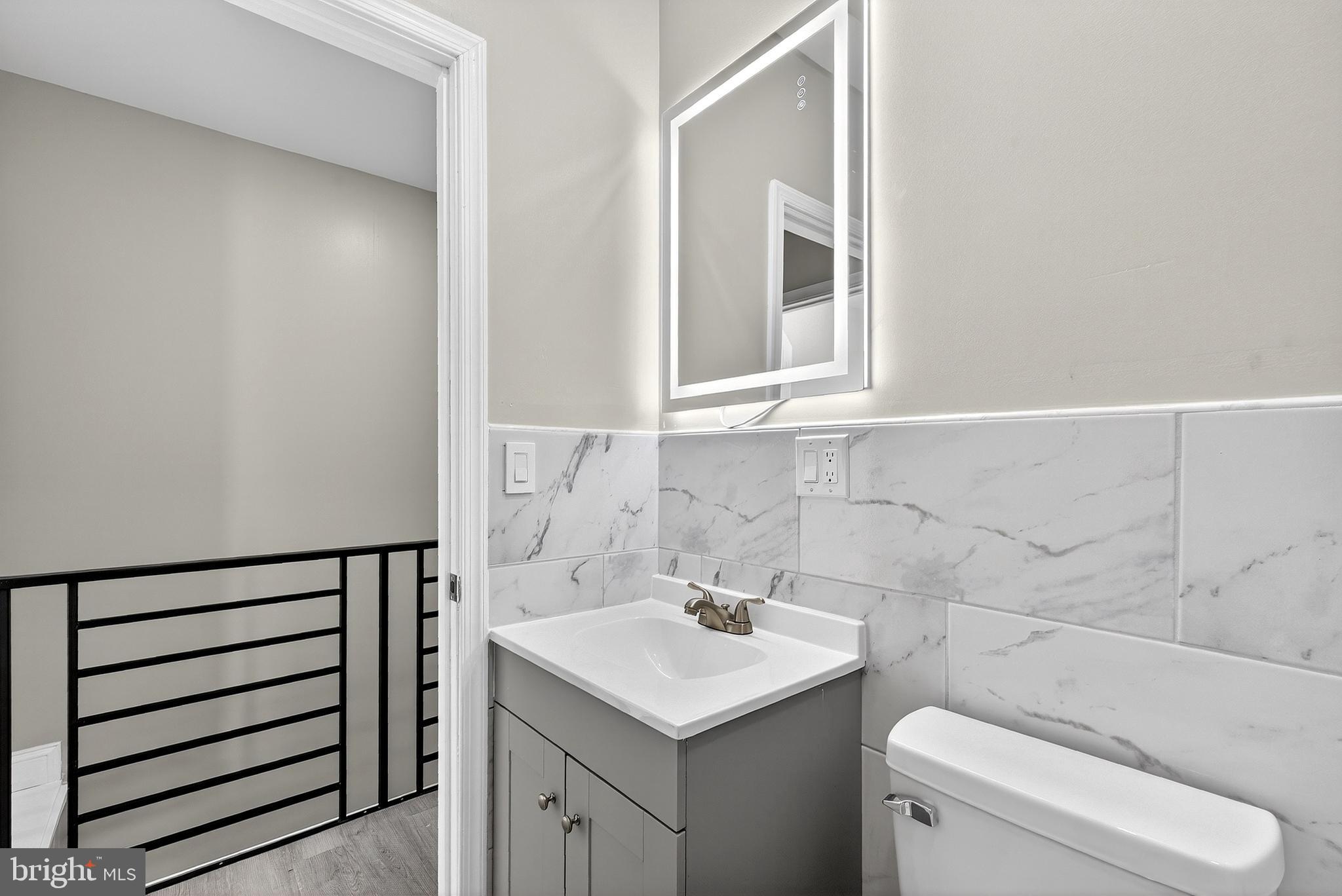 5443 Irving Street Philadelphia, PA 19139 - Photo 26 of 50 a bathroom with a sink toilet and window