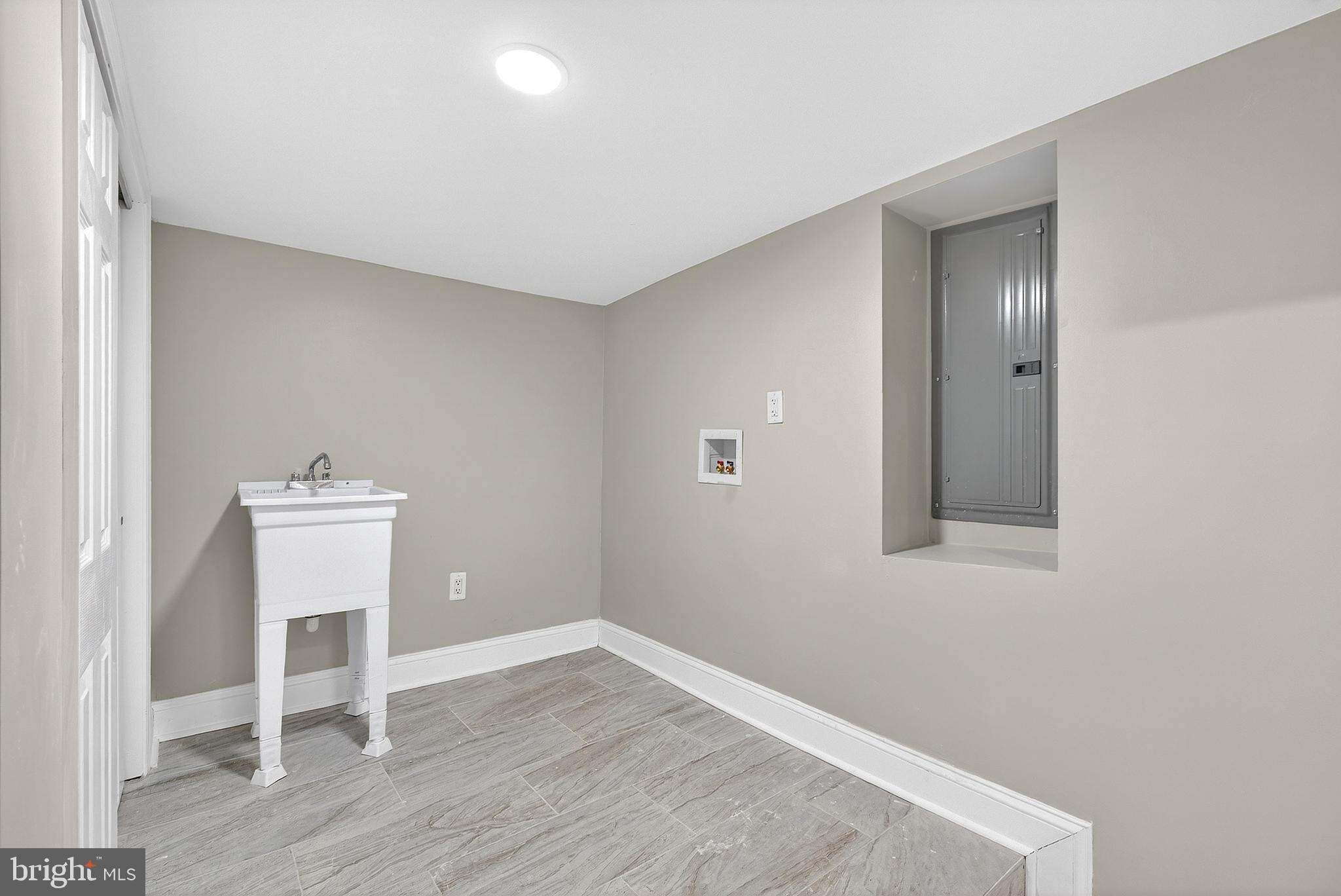 5443 Irving Street Philadelphia, PA 19139 - Photo 43 of 50 an empty room with wooden floor and a window