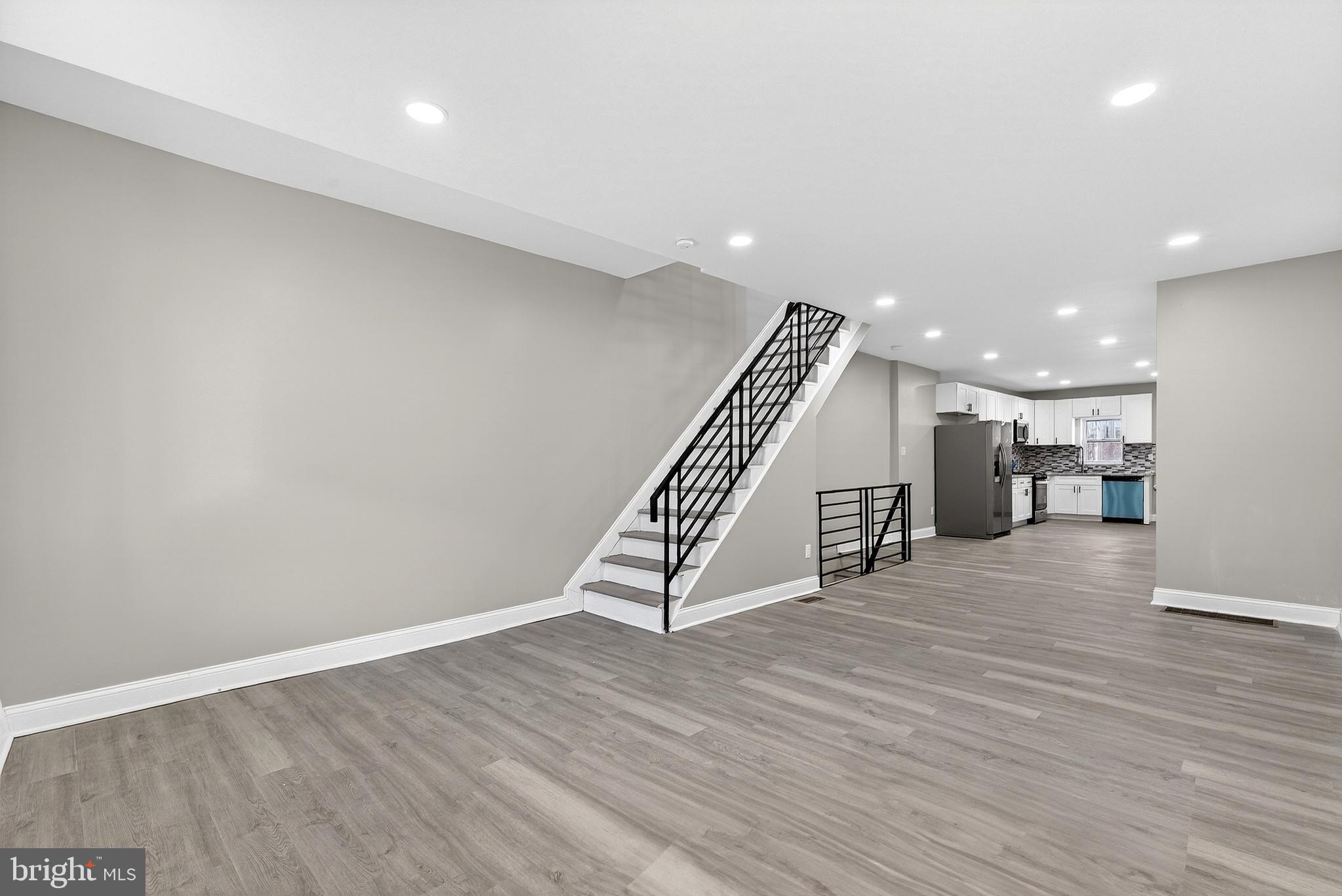5443 Irving Street Philadelphia, PA 19139 - Photo 8 of 50 a view of an empty room with wooden floor stairs and a way to kitchen