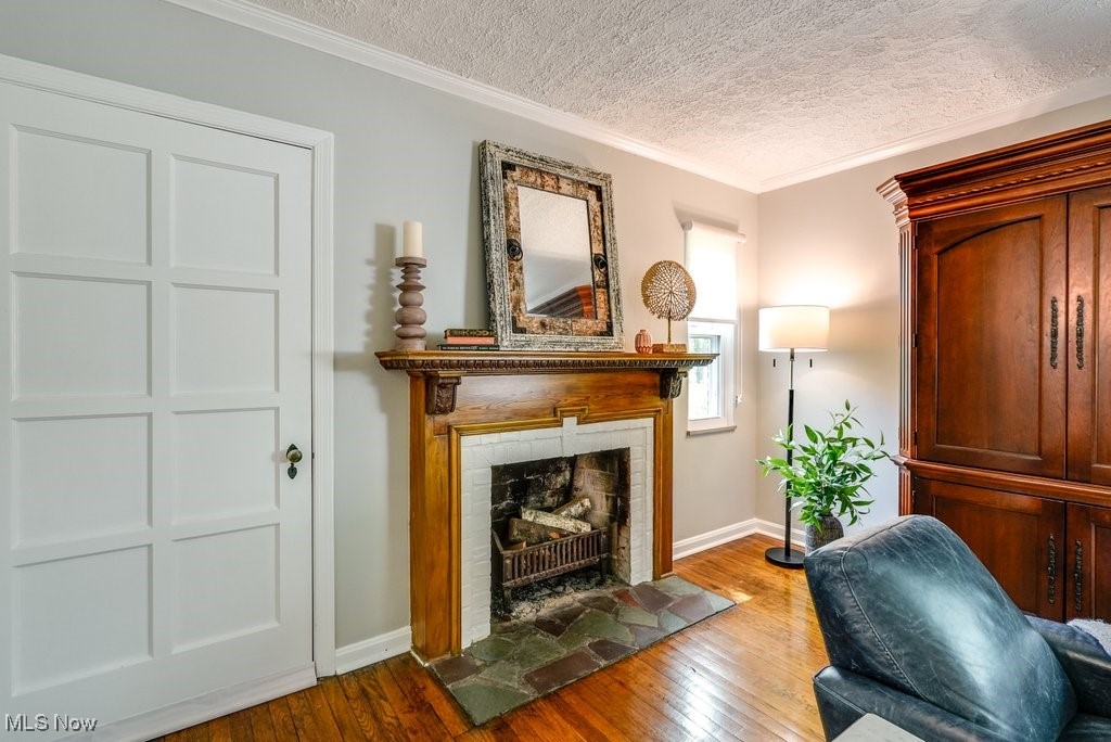 2340 Canterbury Road University Heights, OH 44118 - Photo 12 of 29 Sitting room featuring a textured ceiling, baseboards, hardwood / wood-style flooring, and a fireplace