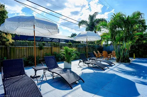 a view of a patio with a table chairs and a potted plant