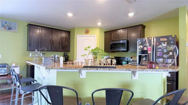 a room with cabinets chairs dining table and chairs