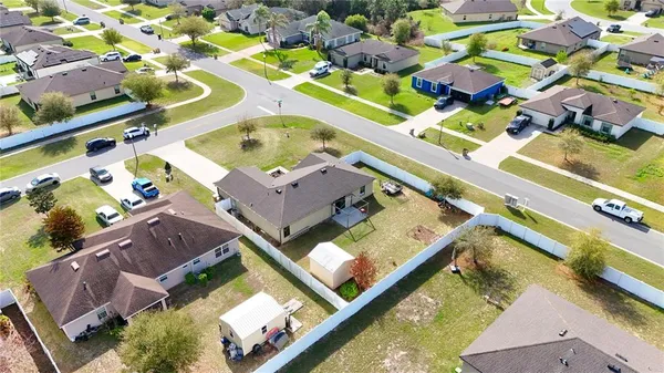 an aerial view of a house a yard and outdoor seating