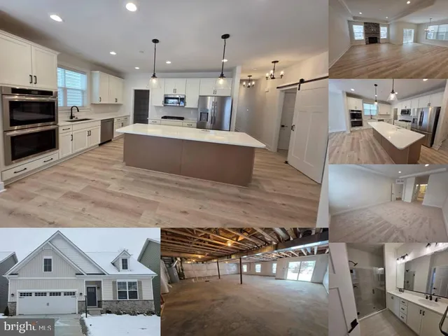 a open kitchen with stainless steel appliances kitchen island granite countertop a sink and a refrigerator