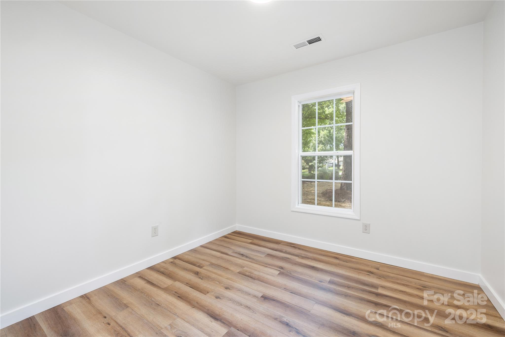 3100 Hickory Grove Drive Monroe, NC 28110 - Photo 11 of 16 an empty room with wooden floor and windows