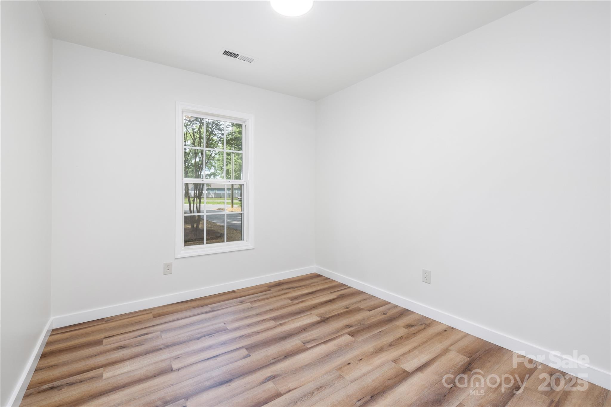 3100 Hickory Grove Drive Monroe, NC 28110 - Photo 10 of 16 a view of an empty room with wooden floor and a window