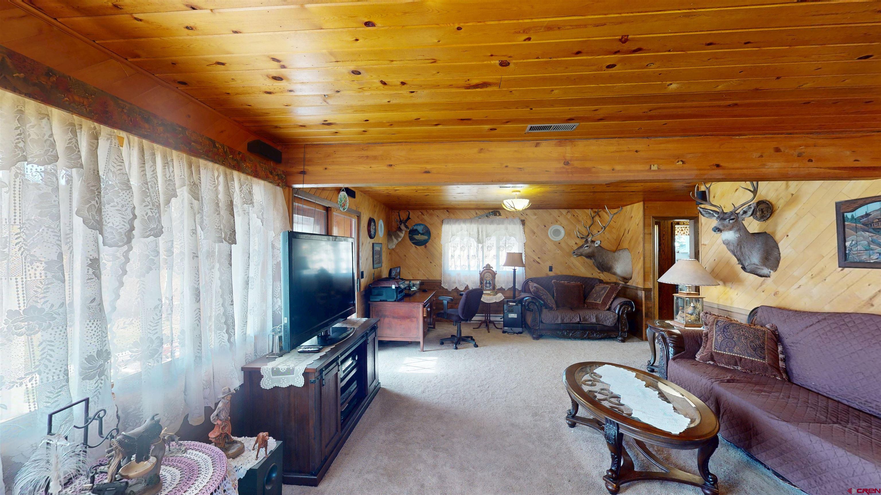 19253 Stevens Gulch Road Paonia, CO 81428 - Photo 25 of 43 a living room with furniture and a flat screen tv