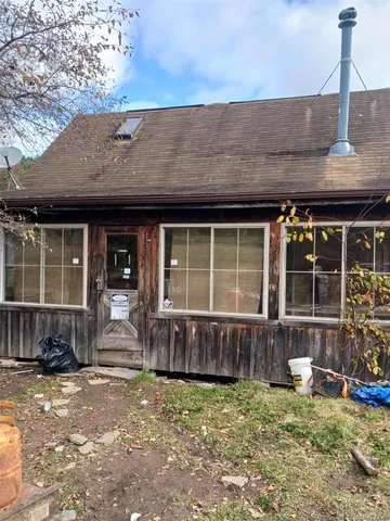 a front view of a house with a garden and patio