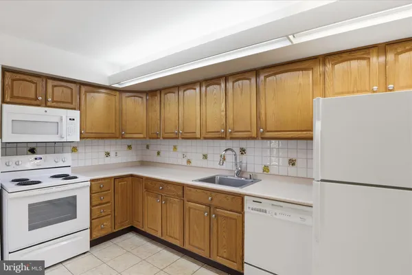 a utility room with cabinets washer and dryer