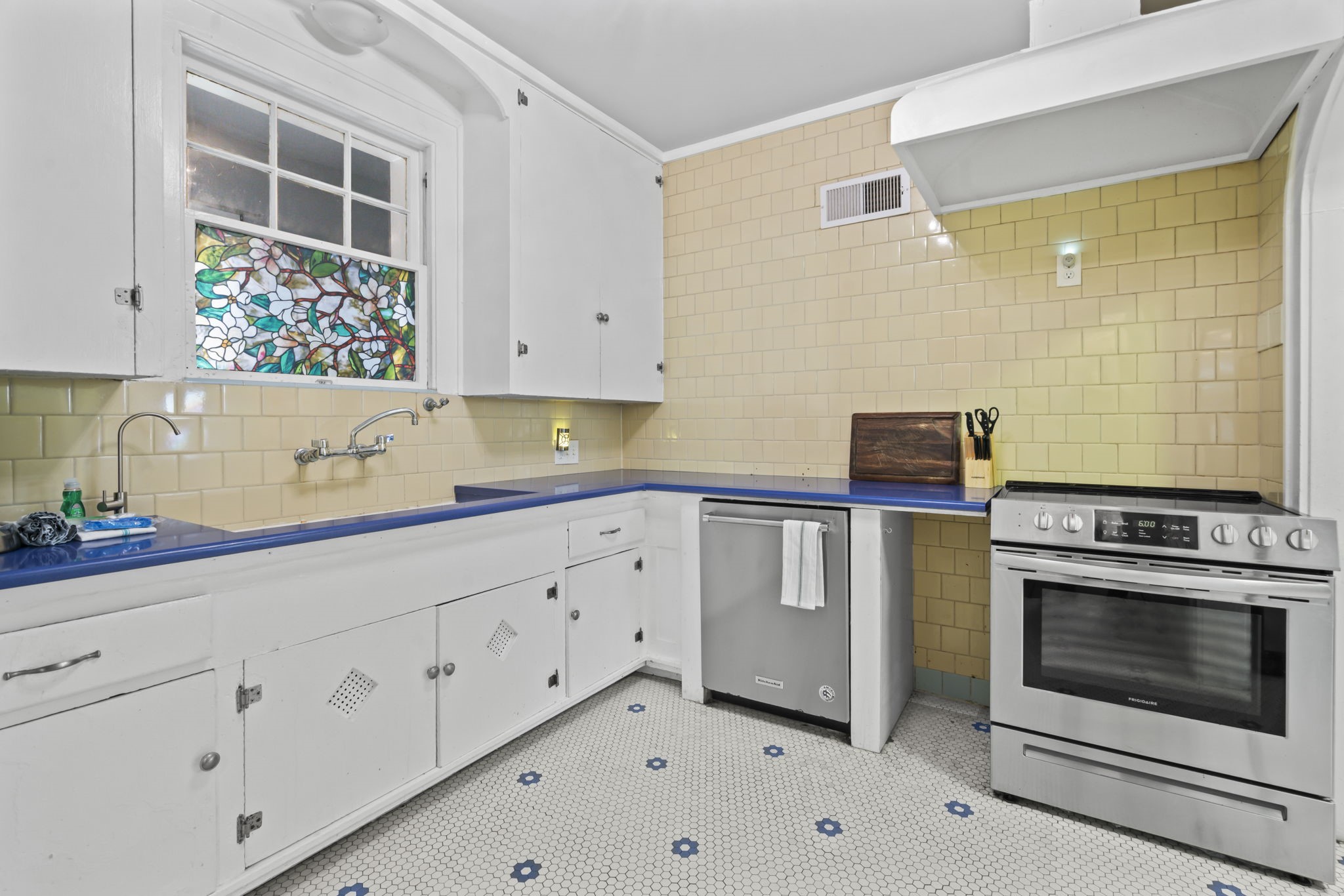 1919 Rosenberg Street Galveston, TX 77550 - Photo 11 of 25 a kitchen with granite countertop white cabinets and white appliances