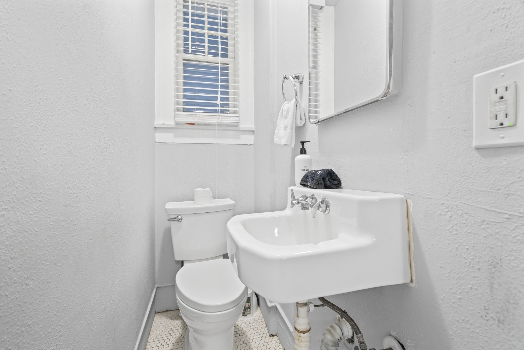 1919 Rosenberg Street Galveston, TX 77550 - Photo 21 of 25 a bathroom with a sink toilet and a mirror