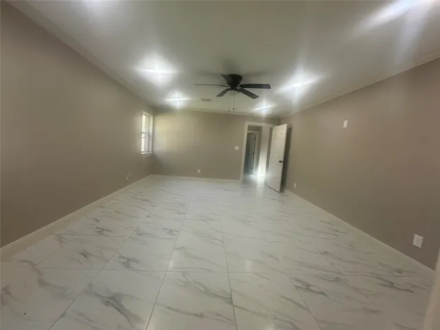 an empty room with windows and fireplace