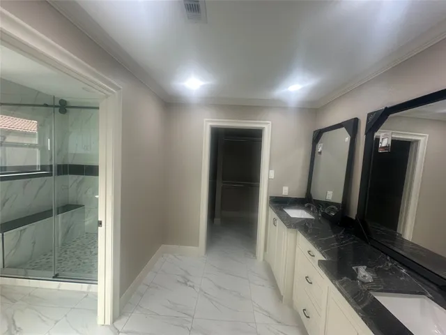 a bathroom with a glass shower door