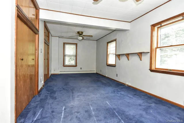 an empty room with windows and closet