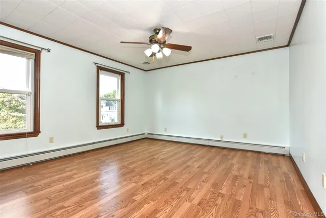 wooden floor in an empty room with a window