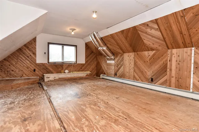 a view of a room with wooden walls and stairs