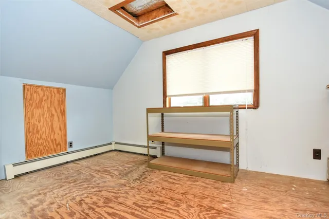 a view of room with window and hardwood floor