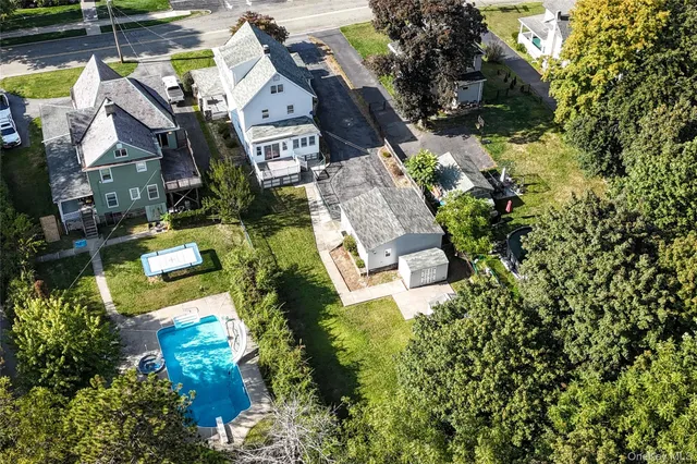an aerial view of residential house with outdoor space and swimming pool