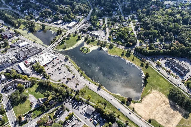 an aerial view of a residential houses with outdoor space
