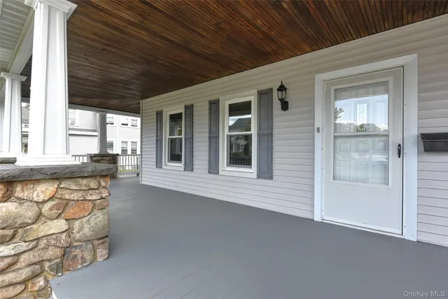 a front view of a house with a large window