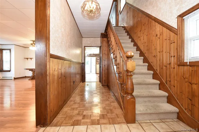 a view of entryway and hall with wooden floor