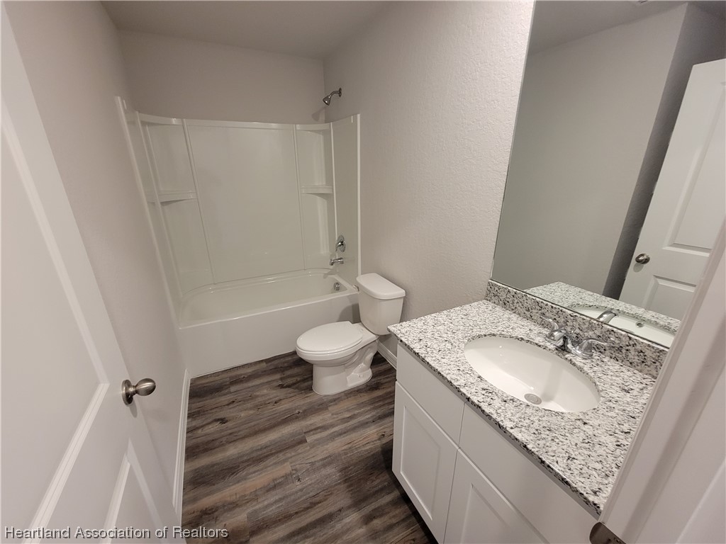 1389 Stone Circle Sebring, FL 33870 - Photo 12 of 39 a bathroom with a granite countertop sink toilet and shower