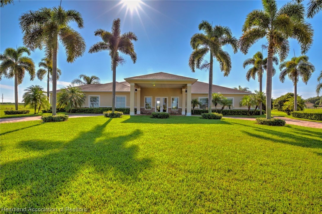 1389 Stone Circle Sebring, FL 33870 - Photo 31 of 39 a view of a swimming pool with a garden and palm trees