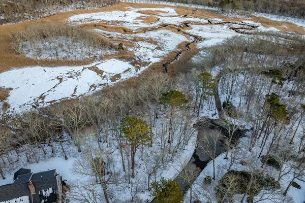 a view of a yard with wooden fence