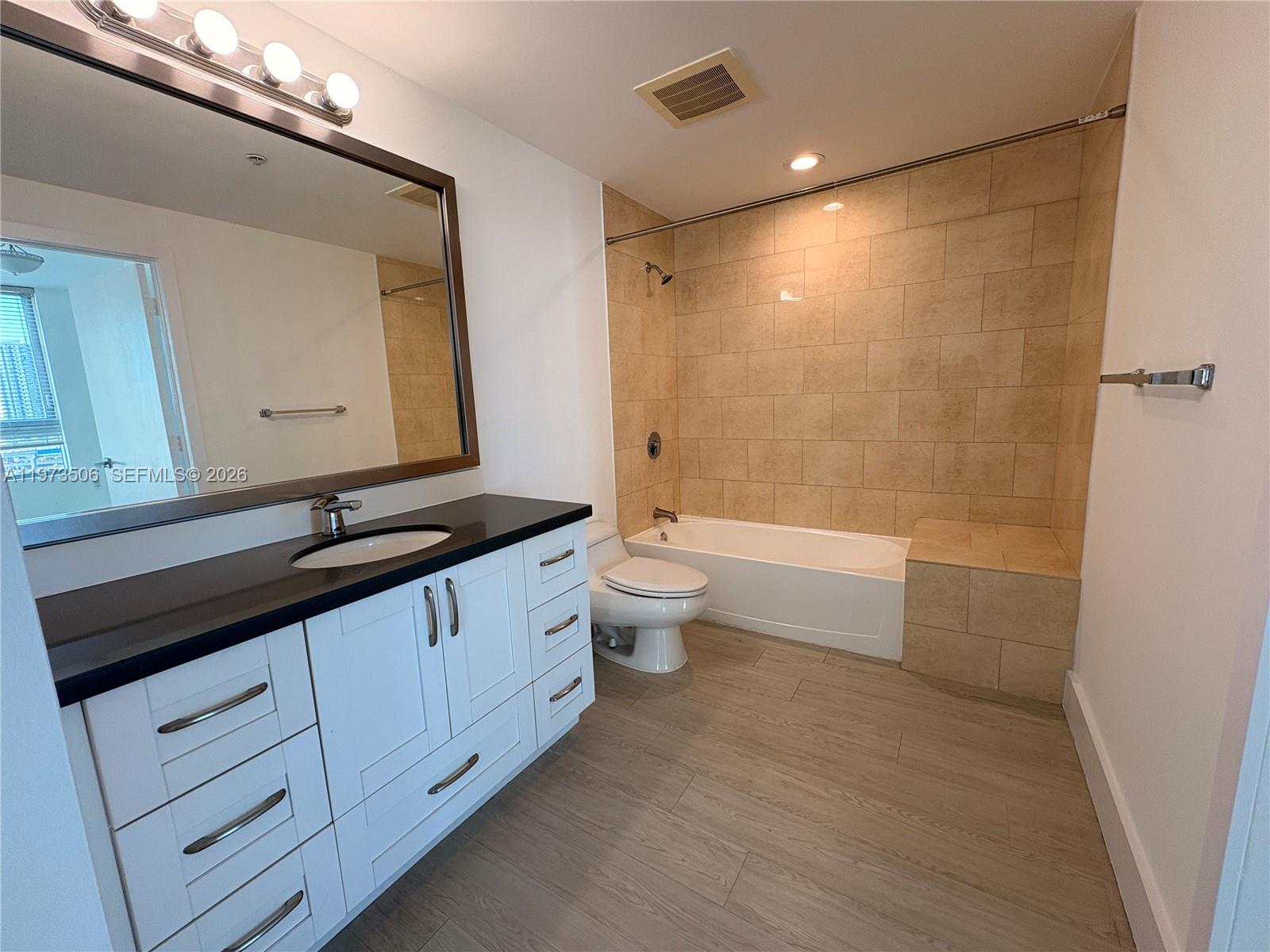 90 Southwest 3rd Street, Unit 1205 Miami, FL 33130 - Photo 11 of 41 a bathroom with a double vanity sink toilet and shower