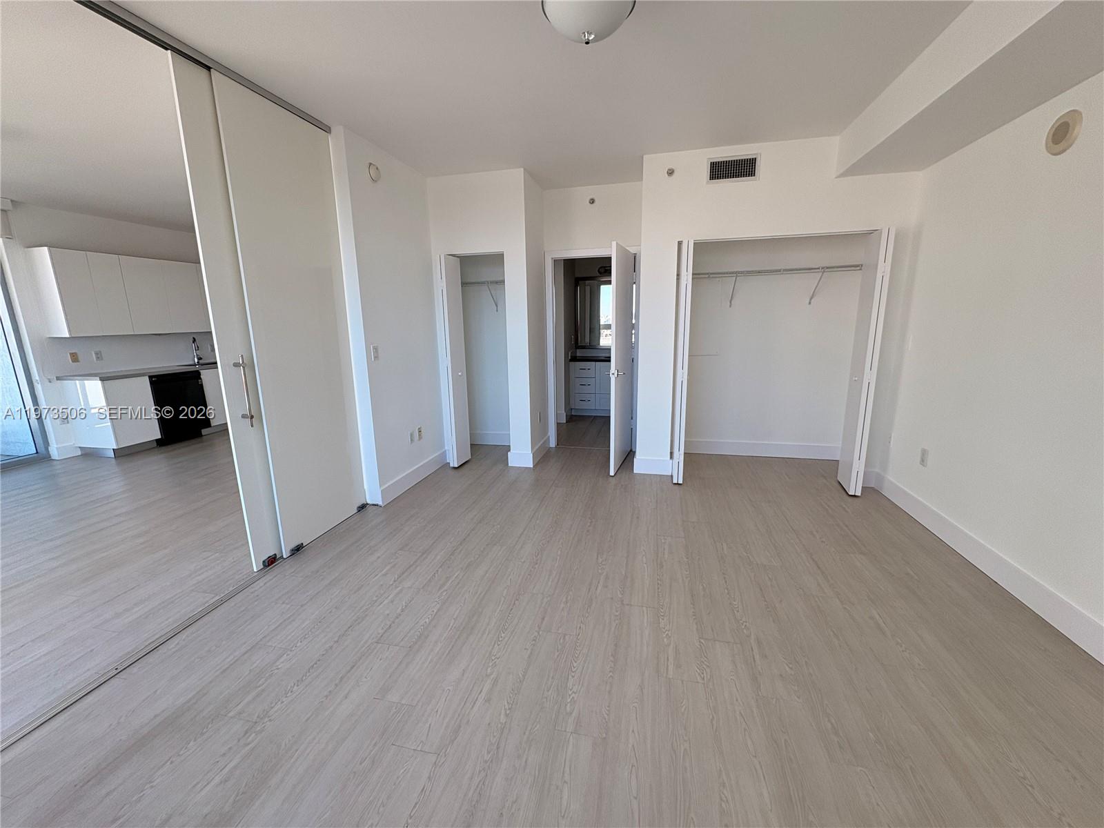 90 Southwest 3rd Street, Unit 1205 Miami, FL 33130 - Photo 12 of 41 an empty room with wooden floor and closet