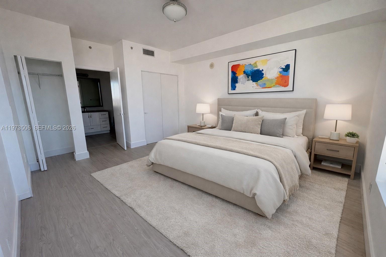 90 Southwest 3rd Street, Unit 1205 Miami, FL 33130 - Photo 2 of 41 a spacious bedroom with a bed and a painting on the wall