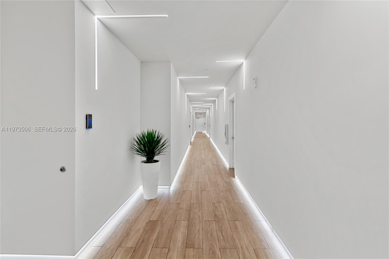 90 Southwest 3rd Street, Unit 1205 Miami, FL 33130 - Photo 35 of 41 a view of a hallway with wooden floor and a bathroom