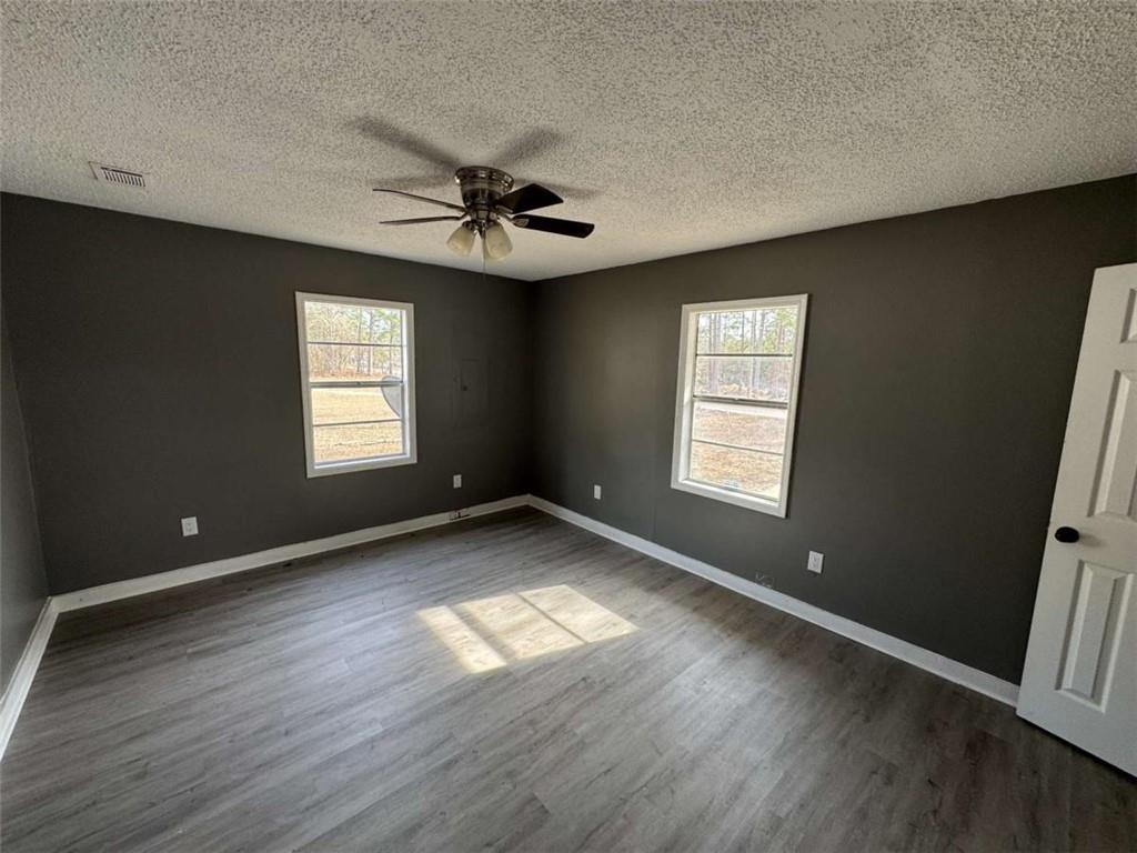 2235 A Moncrieff Street Augusta, GA 30906 - Photo 5 of 10 a view of an empty room with a window and wooden floor