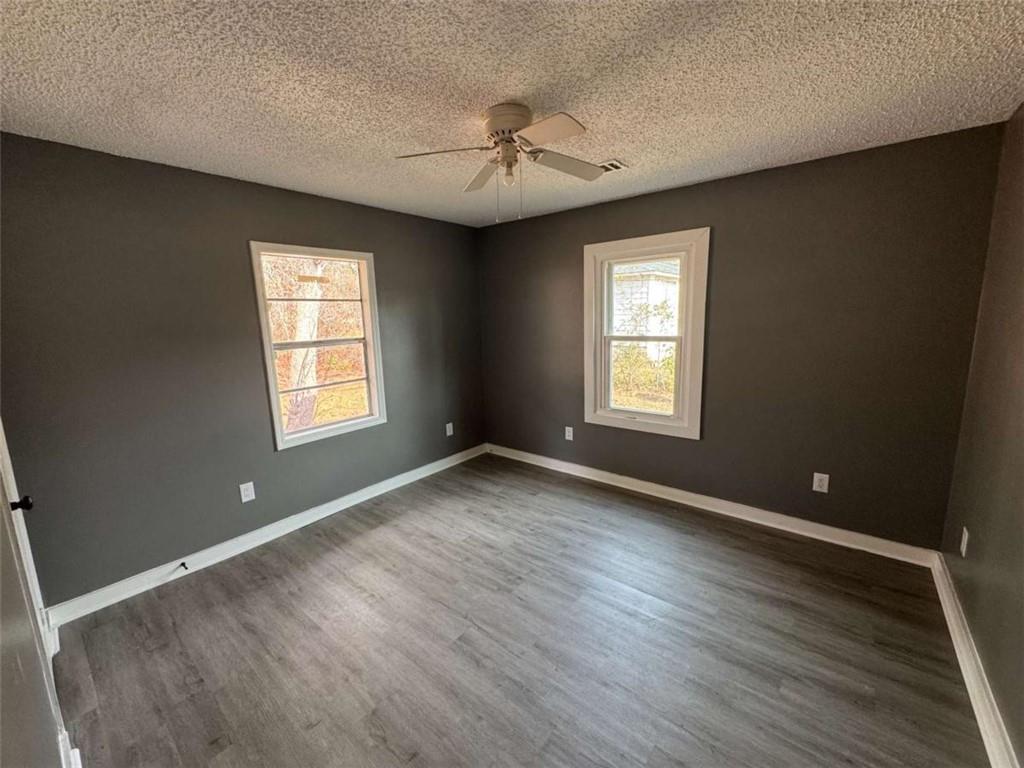 2235 A Moncrieff Street Augusta, GA 30906 - Photo 6 of 10 a view of an empty room with a window and wooden floor