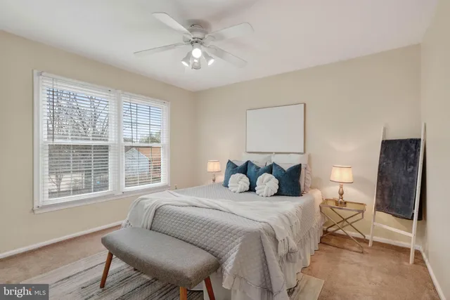 a bedroom with a large bed and a window
