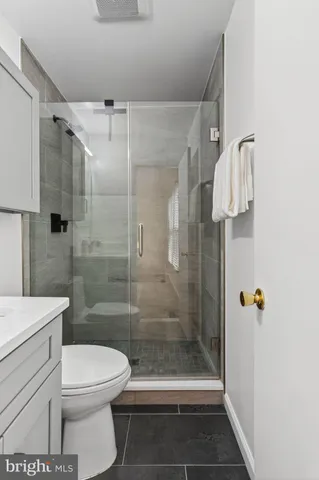 a bathroom with a shower a toilet and a sink
