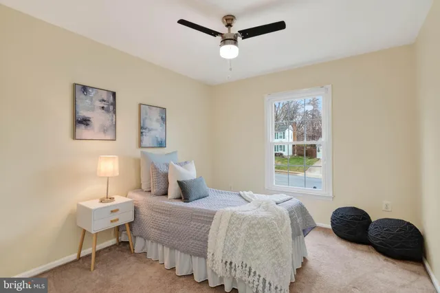 a bedroom with a bed and a lamp