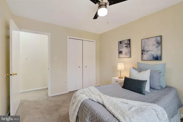 a bedroom with a bed and painting on the wall