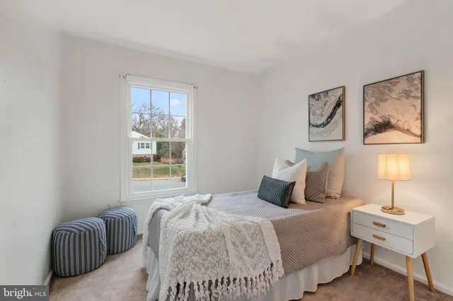 a bedroom with bed and a window