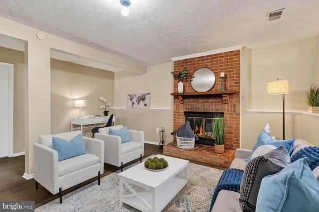 a living room with furniture a fireplace and a table