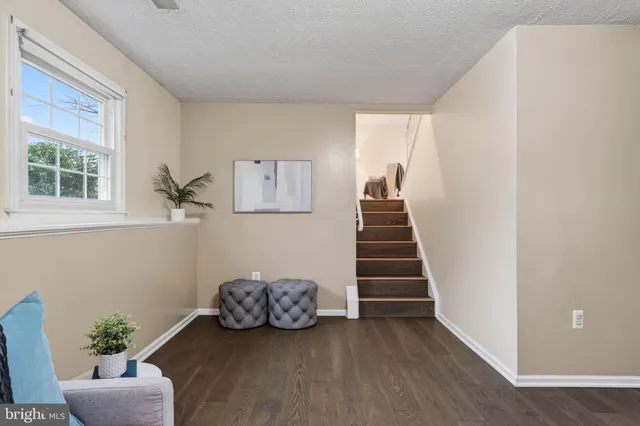 a view of entryway and hall with wooden floor
