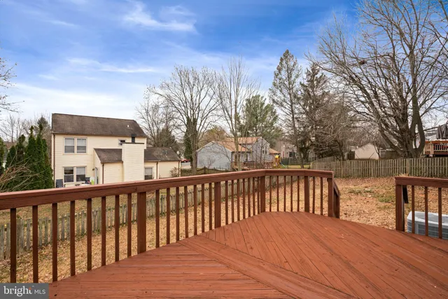a balcony with wooden floor and lake view