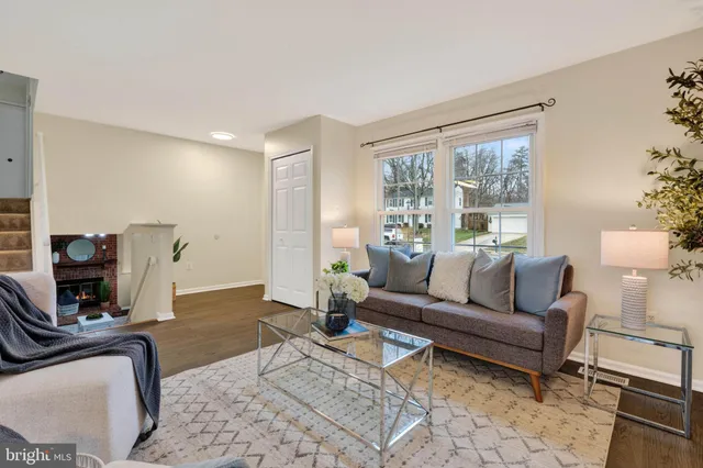 a living room with furniture a rug and a large window