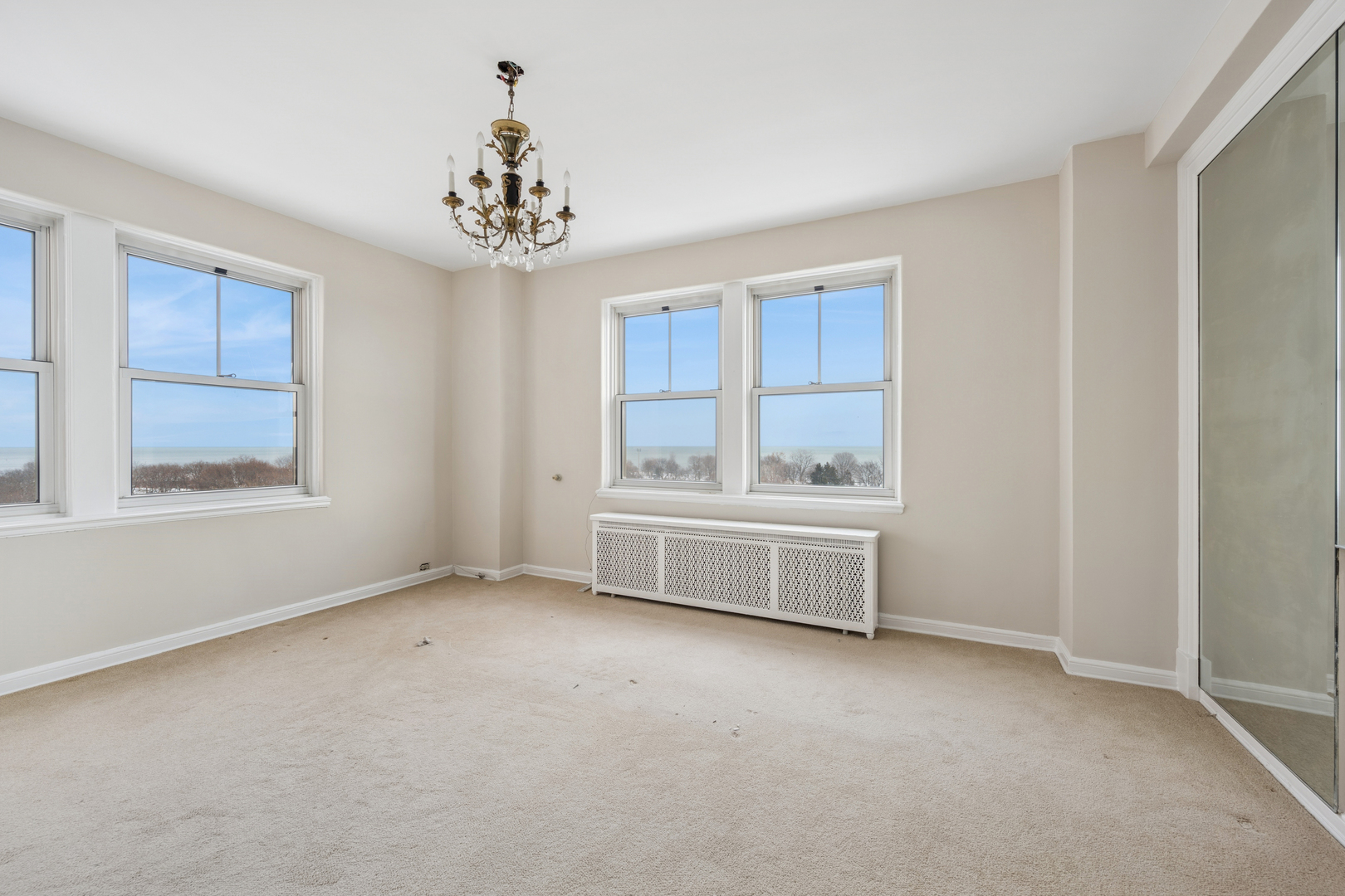 5555 North Sheridan Road, Unit 602 Chicago, IL 60640 - Photo 13 of 20 an empty room with windows and cabinet