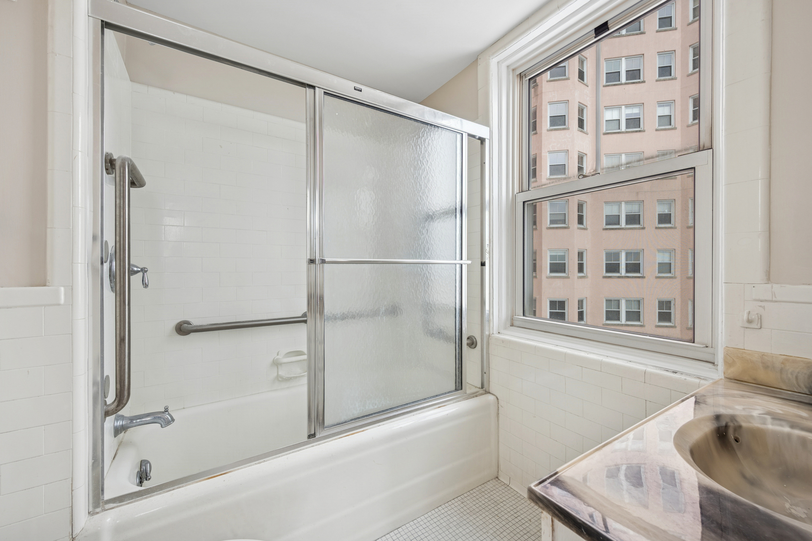 5555 North Sheridan Road, Unit 602 Chicago, IL 60640 - Photo 14 of 20 a bathroom with a bathtub and a shower