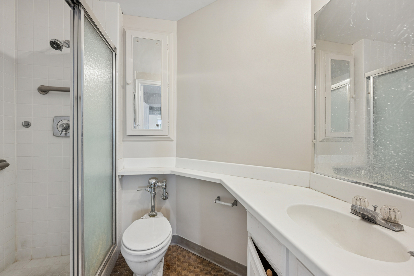5555 North Sheridan Road, Unit 602 Chicago, IL 60640 - Photo 16 of 20 a bathroom with a sink a toilet and shower
